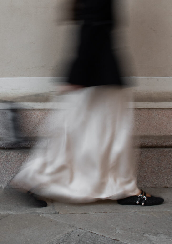 Off Duty - Bride in white dress descending stone stairs alone 