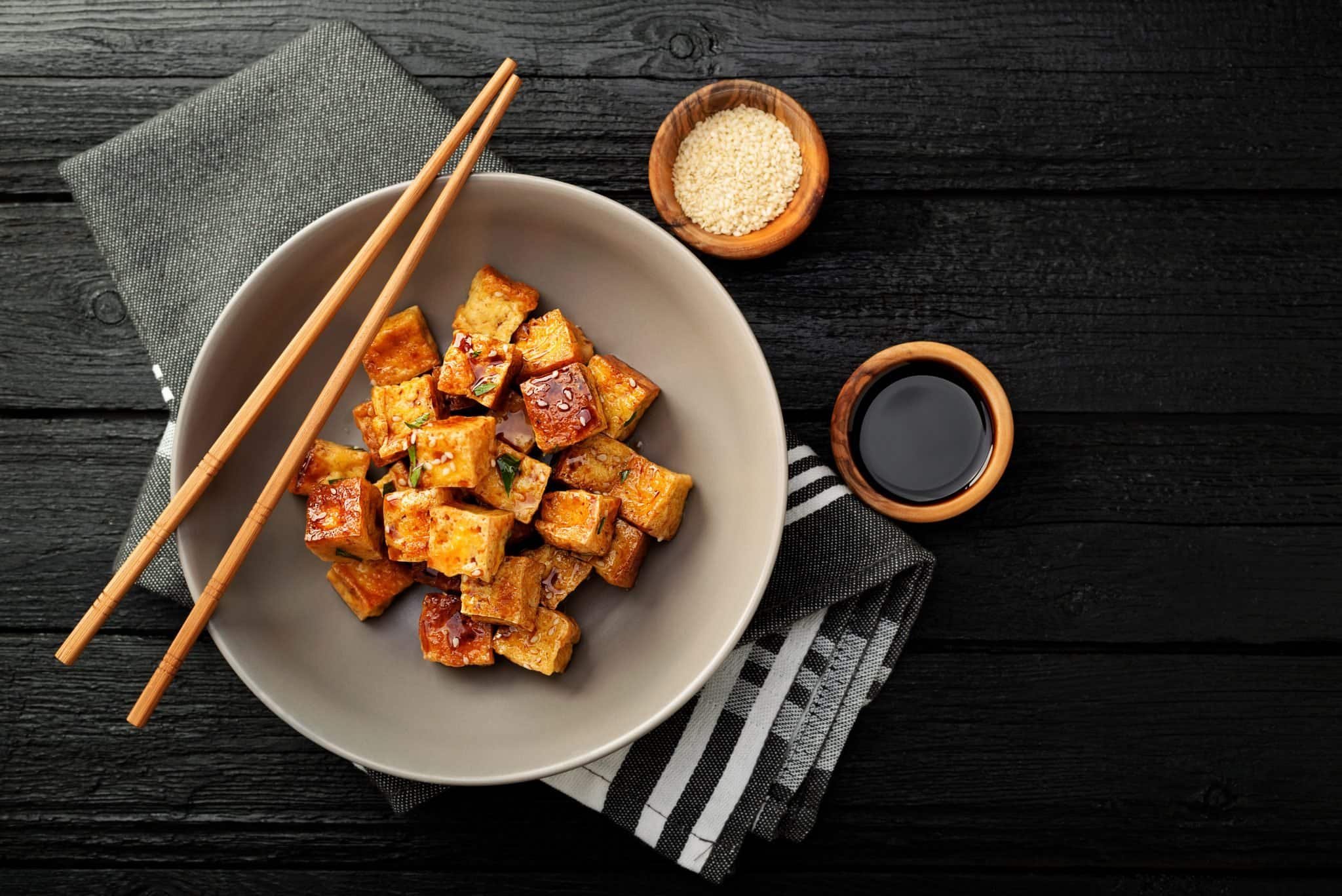 tofu in a plate with chopsticks