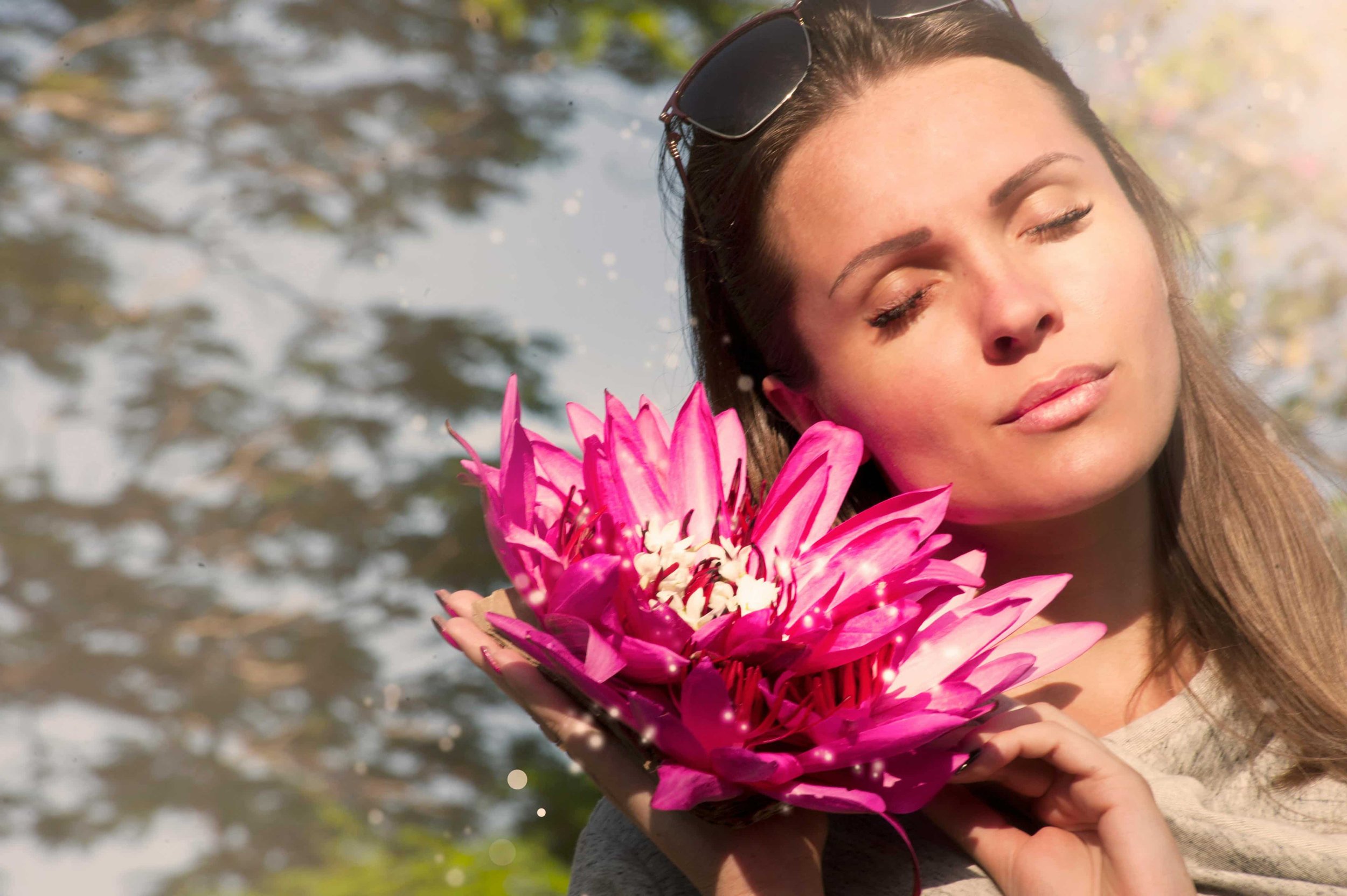 woman holding a pig, pink flower, eyes closed