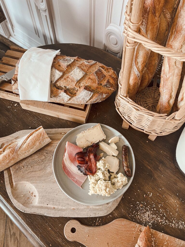 French charcuterie board with fresh bread and artisanal cheeses