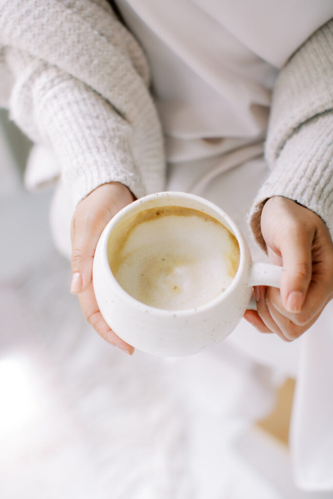 woman holding a latte drink