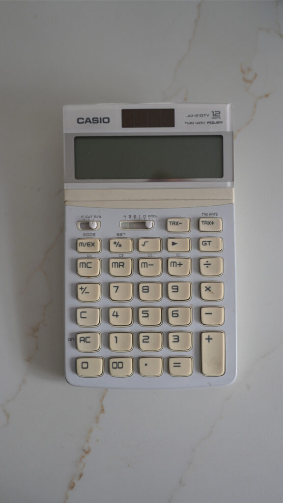 A casio calculator on white surface