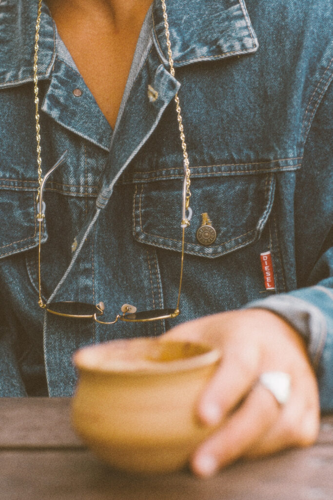 A hand holding a ceramic cup. 