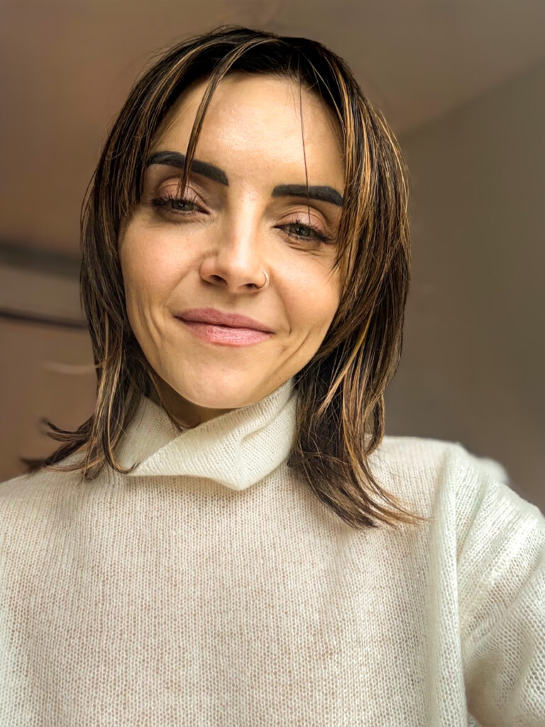 Selfie of the author in white turtleneck, ready to teach clients how to heal yourself.