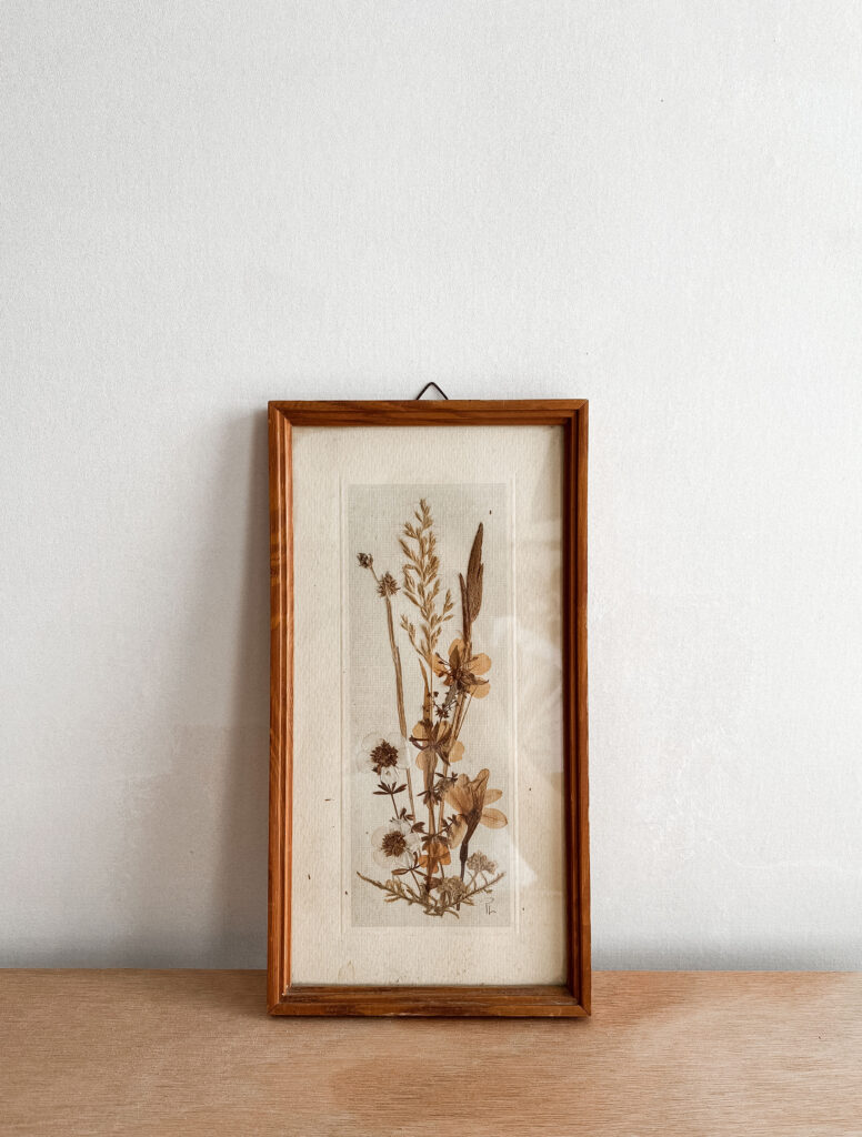 dried flowers in a wooden frame. 