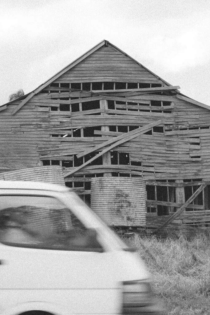 Subtle-Moments-Abandoned-wooden-barn-structure-with-broken-windows-and-deteriorating-facade