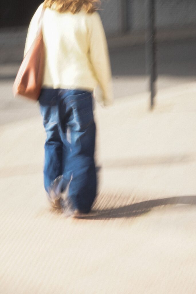 Woman walking outside- blurry image. 