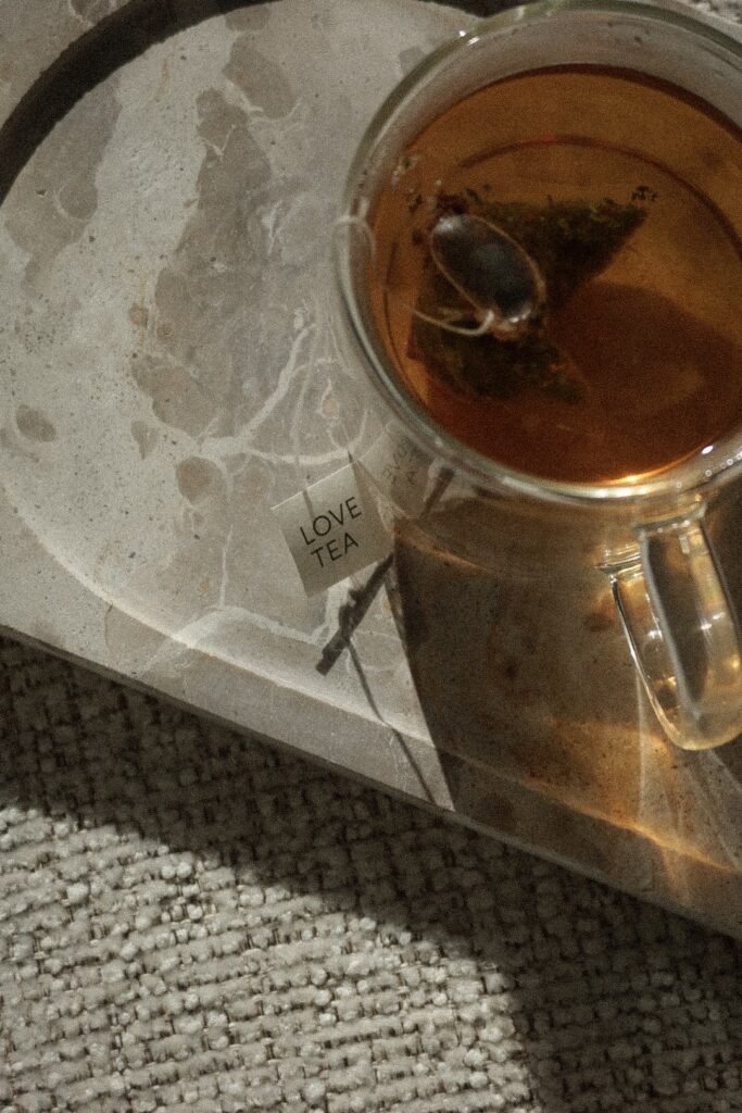 Steaming cup of tea with love-labeled tea bag nearby