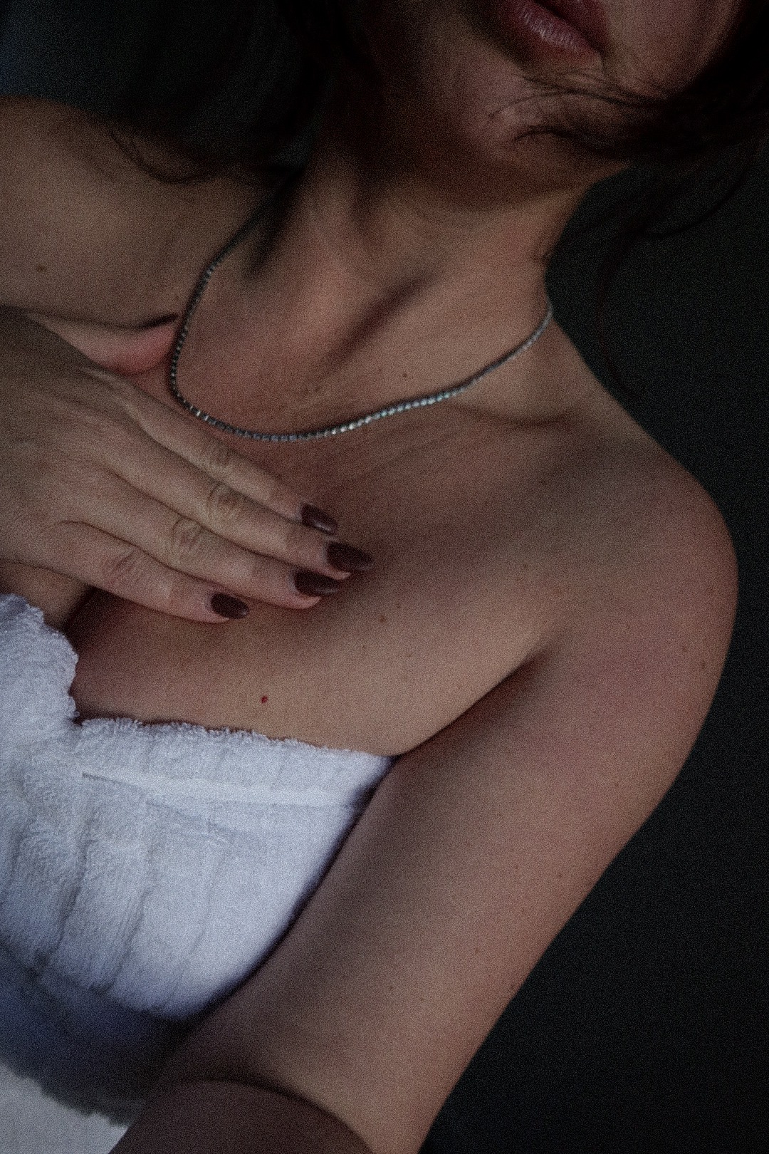 Grounded - Woman in white towel wearing delicate diamond necklace