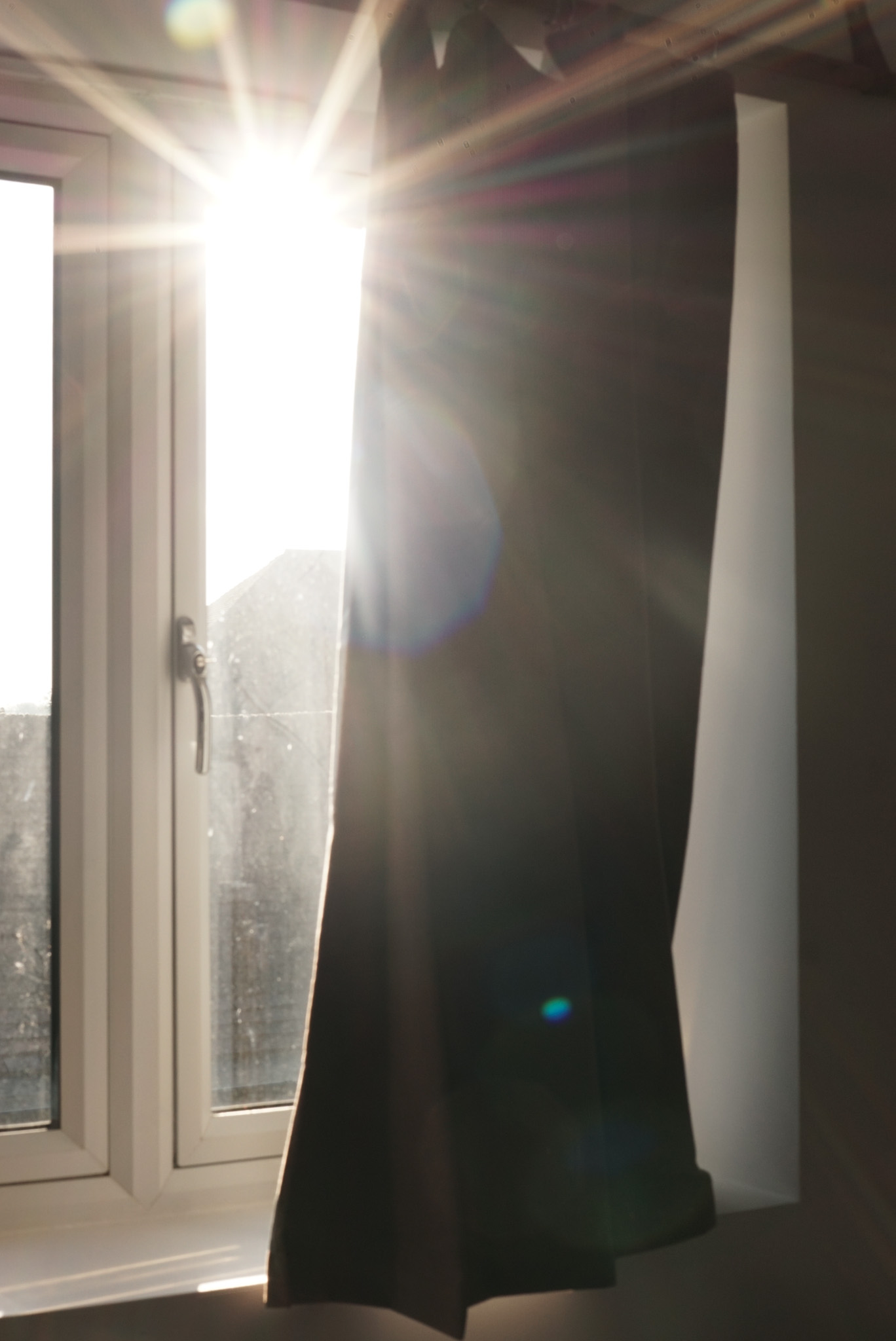 Bright sunlight streams through open doorway and window