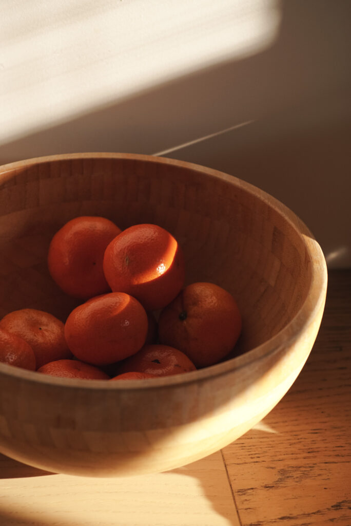 Fresh red tomatoes in wooden bowl_ warm natural sunlight 
