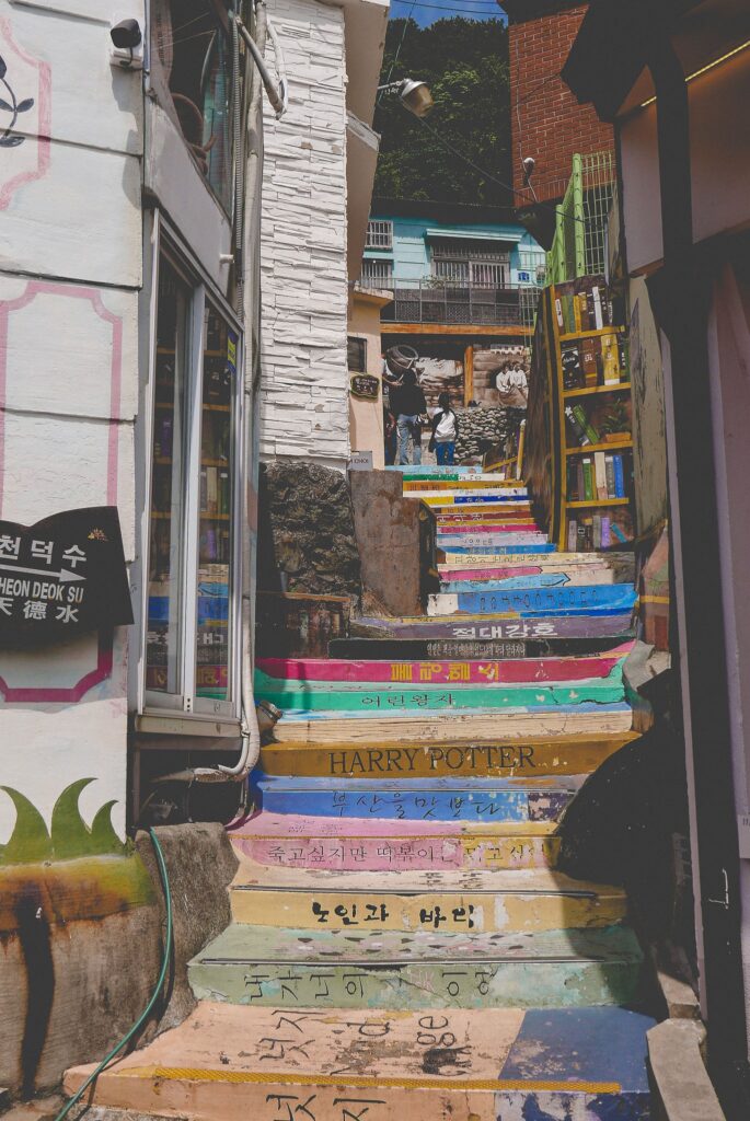 Colorful book-themed staircase in vibrant urban alleyway