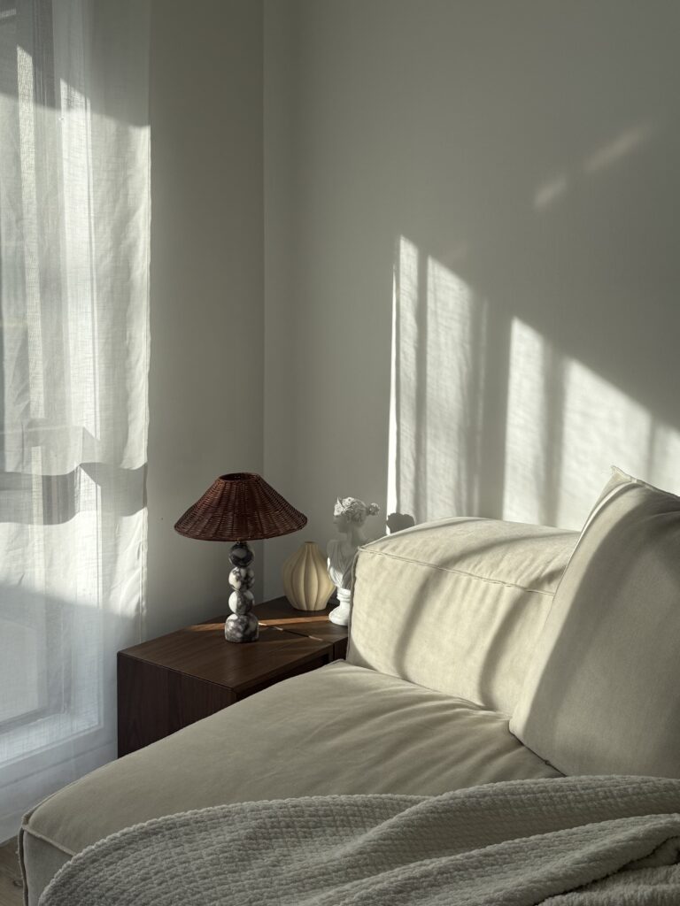Minimalist bedroom with natural light and neutral tones 