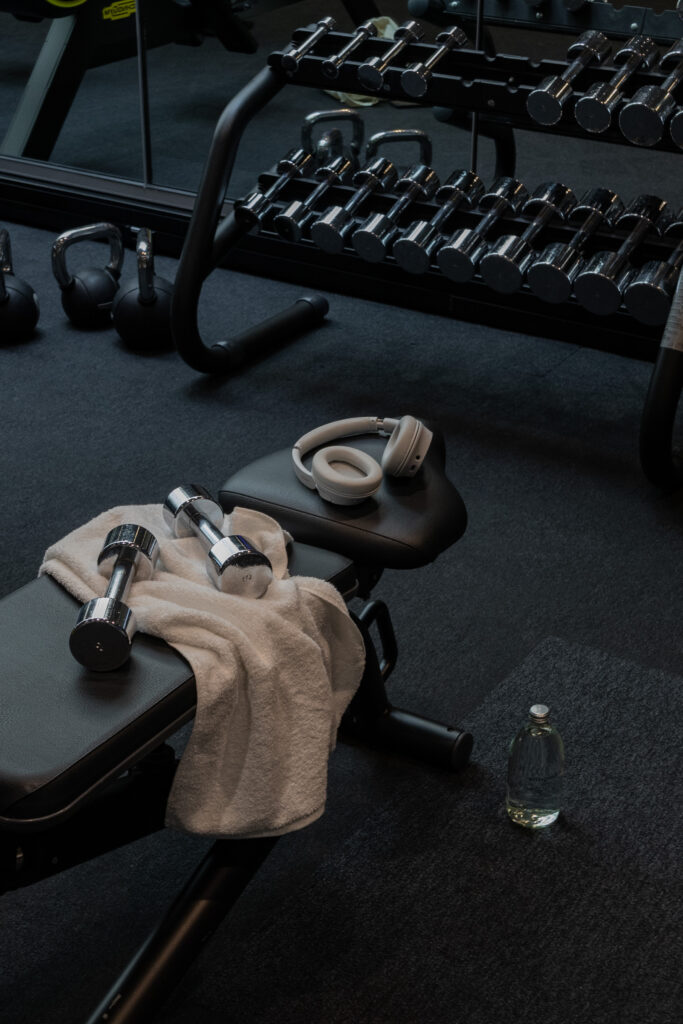 Premium gym equipment and accessories arranged on dark floor 