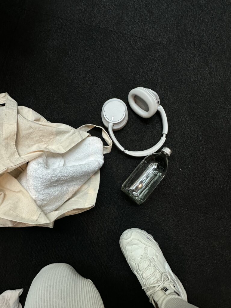 White headphones and sneaker flat lay overhead view